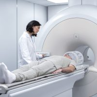 doctor-getting-patient-ready-ct-scan-scaled.jpg