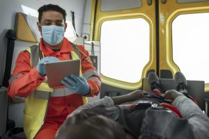 medium-shot-paramedic-holding-tablet-scaled.jpg