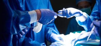 Surgeons passing scissors to each other